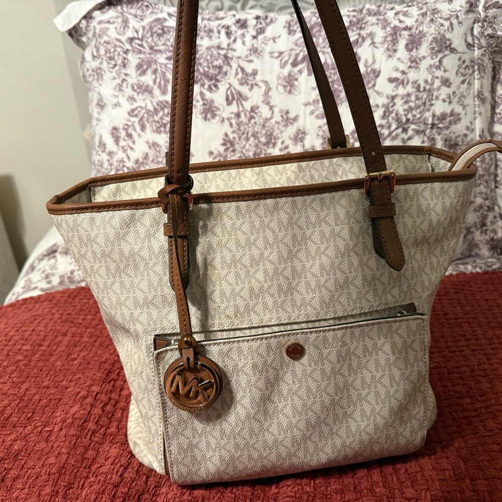 Medium Tan MK purse with brown handles slight.